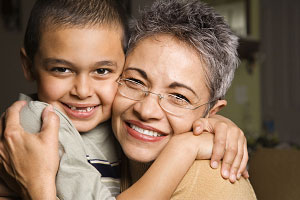 grandma hugging boy at magic show for kids birthday party grandma hugging boy at magic show for kids birthday party